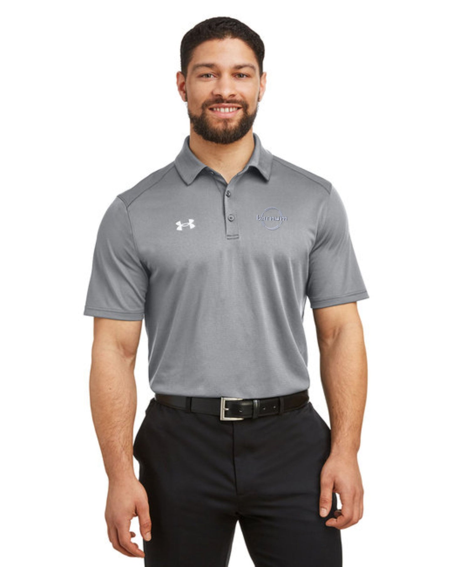 Smiling man wearing a gray polo shirt with a logo, standing confidently.