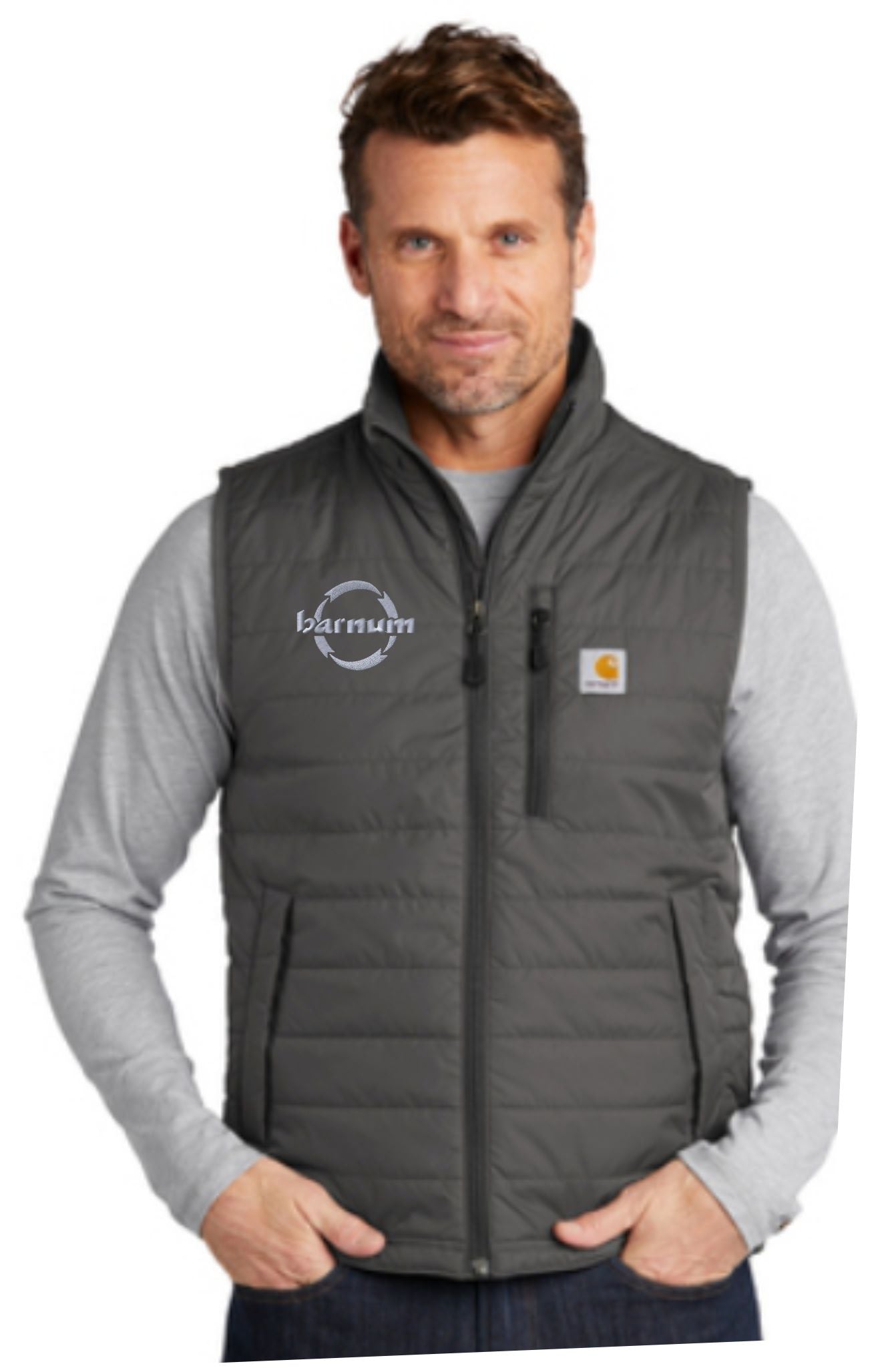 Man wearing a gray puffer vest over a long-sleeve shirt, featuring a logo on the left side.