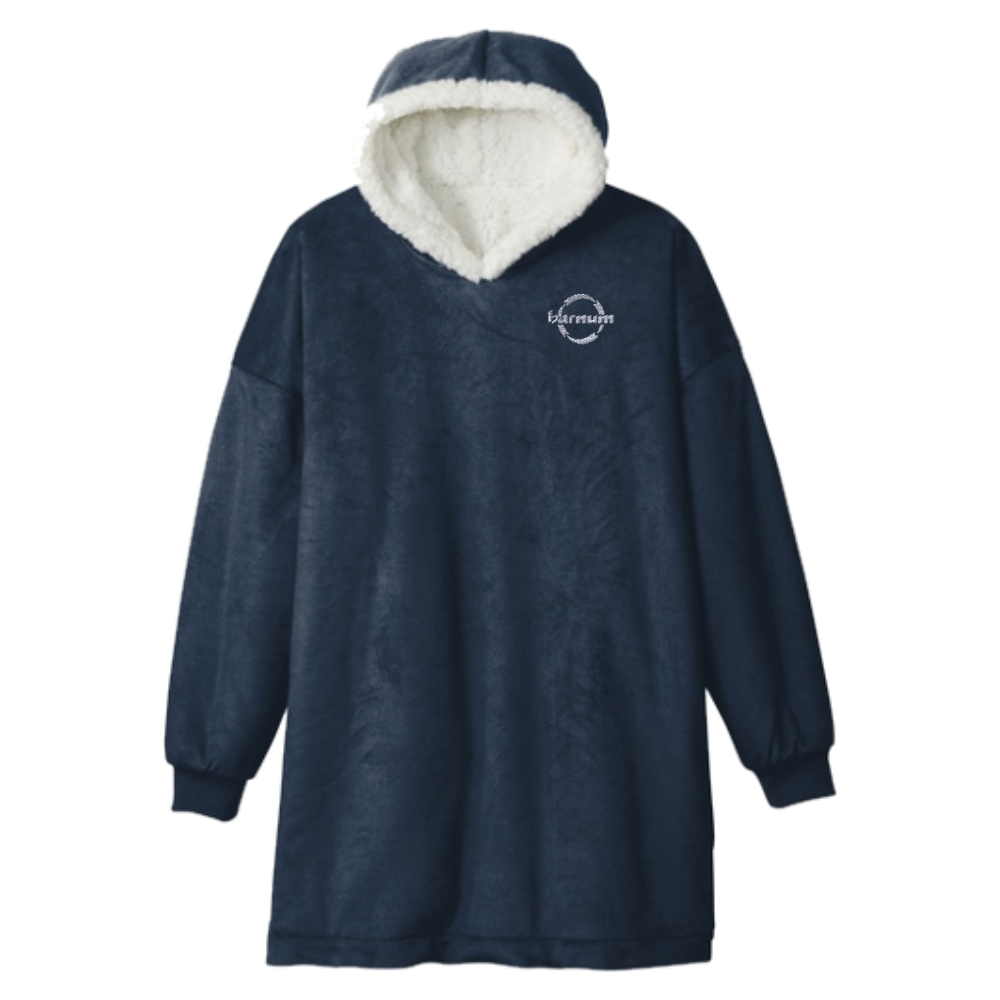 Navy blue hooded blanket with a white fleece lining and a white barnum logo on the left chest.