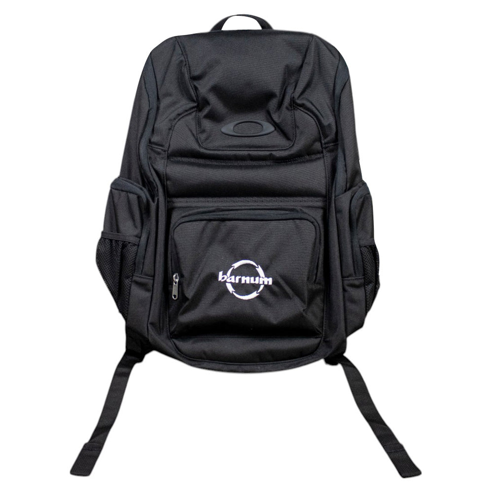 front of black backpack with multiple pockets and the white barnum logo embroidered across the front pocket. 