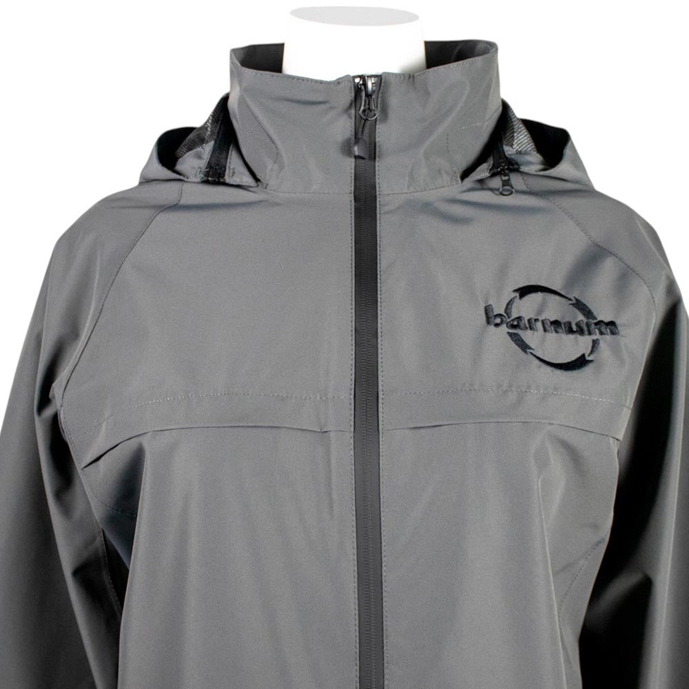 Close up of chest of grey rain jacket with black zippers and a black barnum logo. 