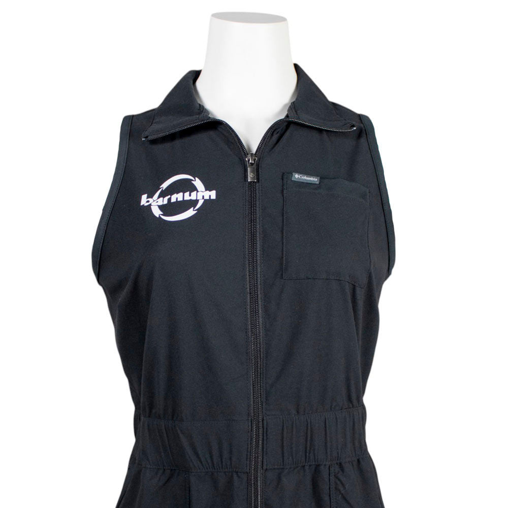 Close up of chest of black sleeveless dress with a white Barnum logo on the chest.